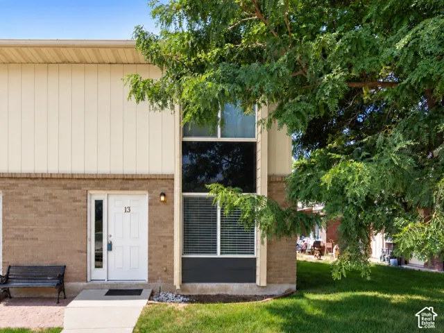 Brick and siding exterior with mature landscaping
