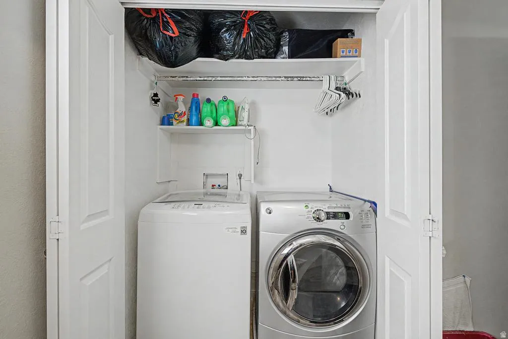 Laundry closet featuring a top-load washing machine and a front-load dryer