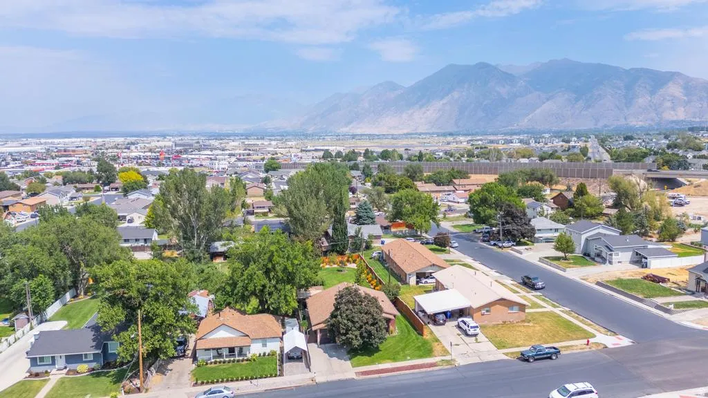 Aerial perspective showcasing this residential property situated on a tree-lined street within an established neighborhood