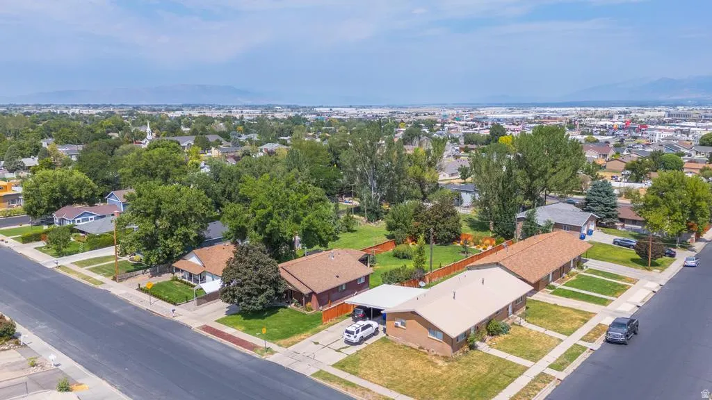 Aerial perspective of a neighborhood with residential structures and mature trees