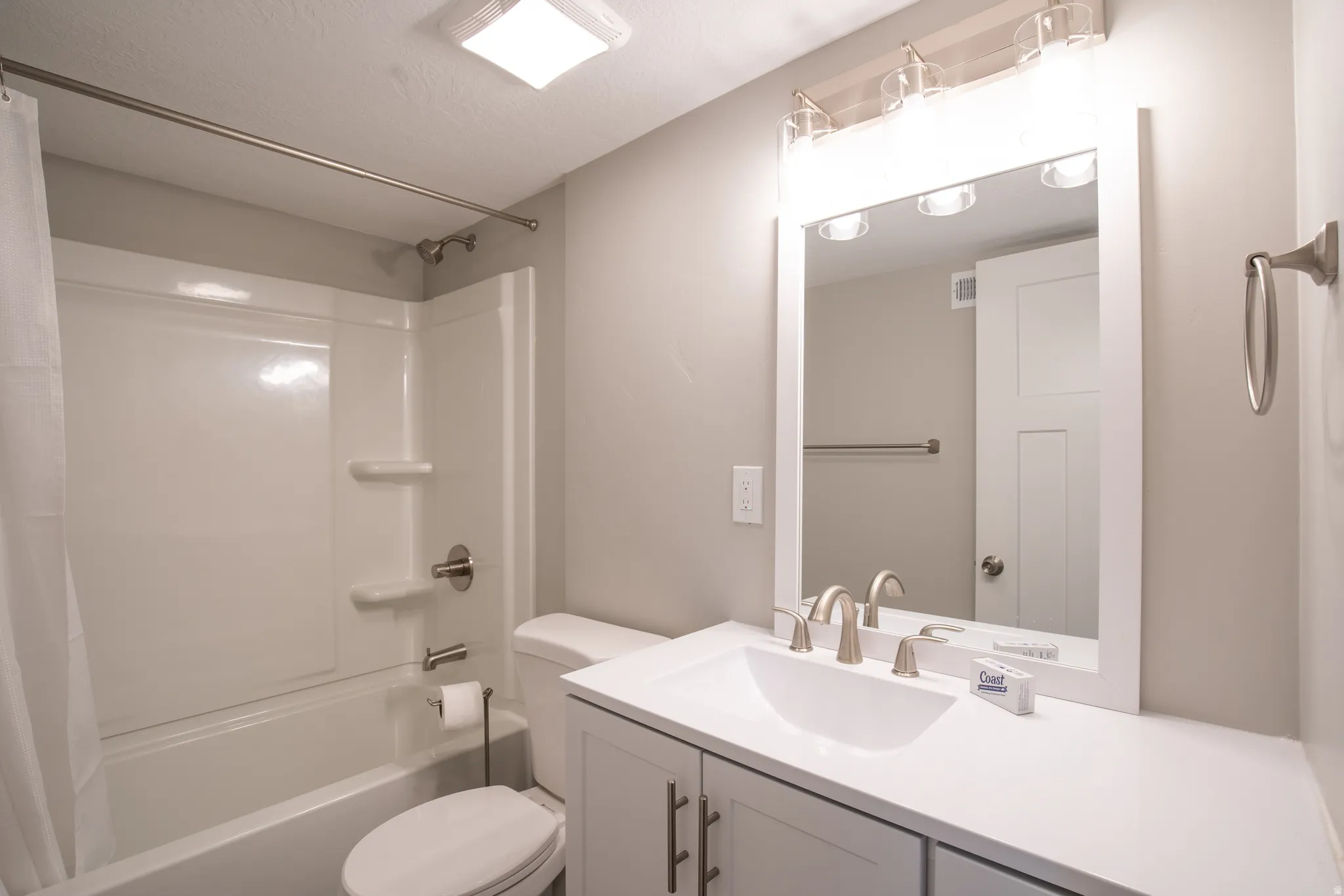 Integrated shower/tub combination with brushed nickel fixtures
