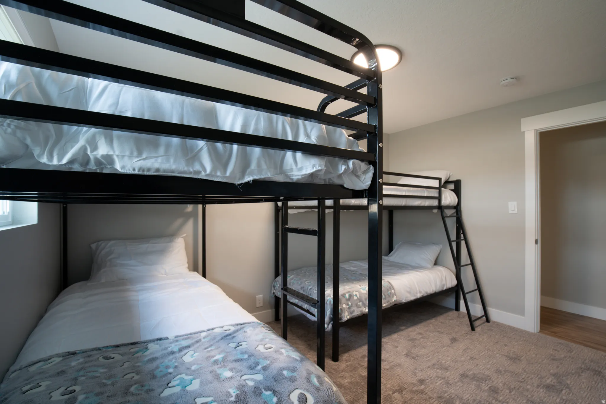 Wall-to-wall carpeting, recessed ceiling lighting, and a white trim doorway