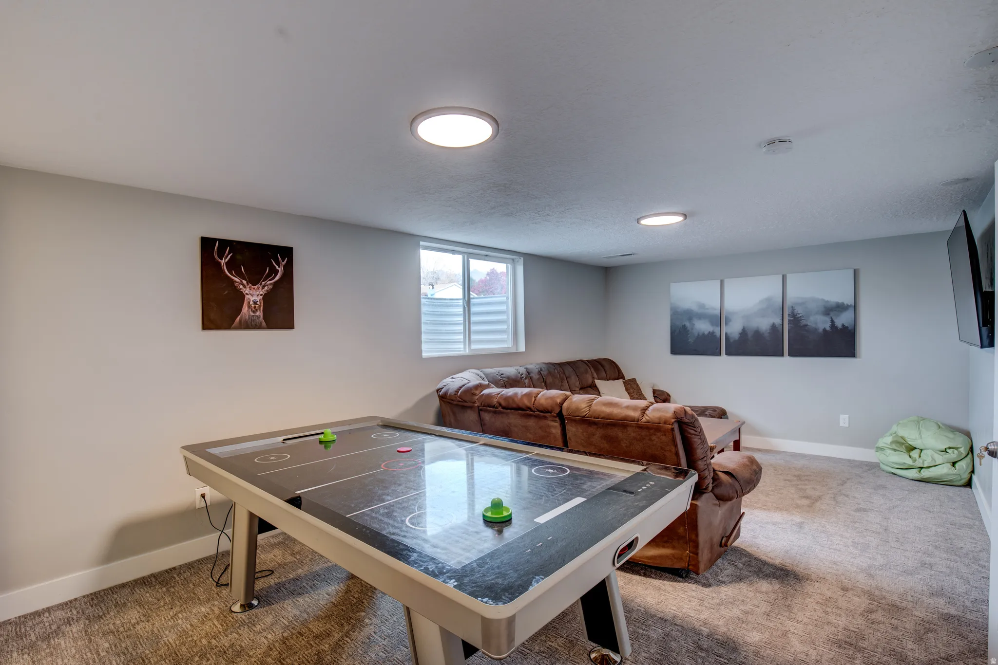 Recessed lighting fixtures, light gray wall paint, white trim, and a window with horizontal blinds