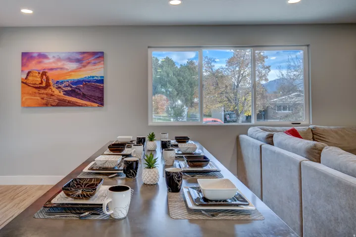 Open-concept living area with recessed lighting, large windows, and light-tone wood-finish flooring