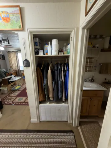 Recessed closet with built-in shelving and hanging rod