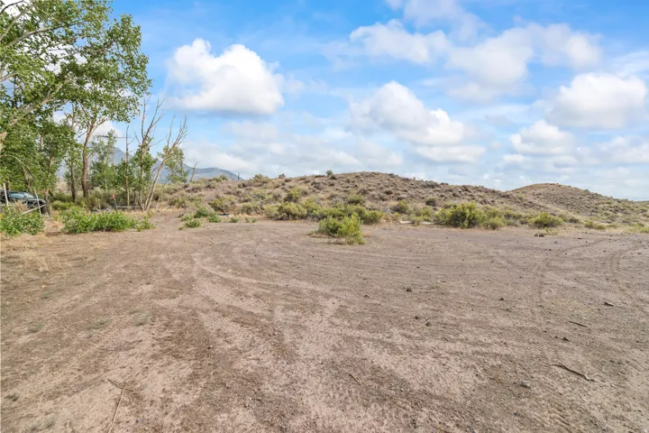 Expansive open land with natural terrain and scattered brush