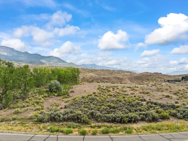 Expansive land parcel with surrounding mountains and scattered vegetation