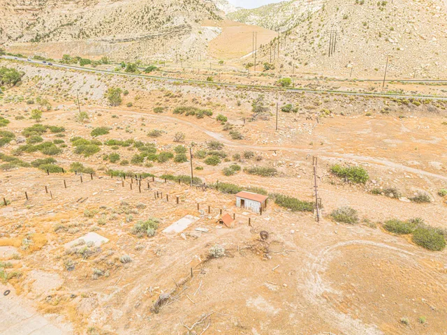 Expansive open land with natural terrain and distant mountains