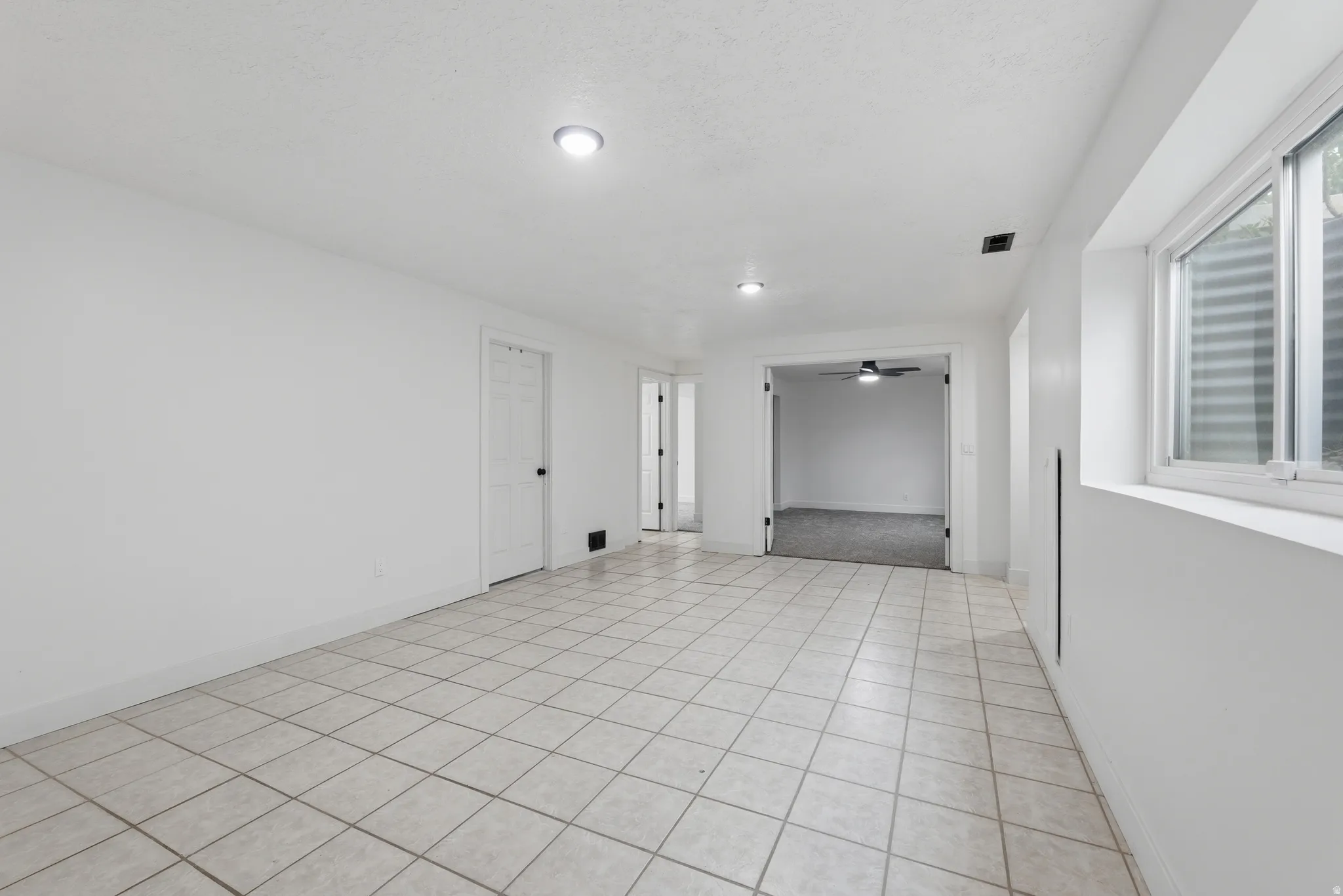 White tile flooring complemented by recessed lighting