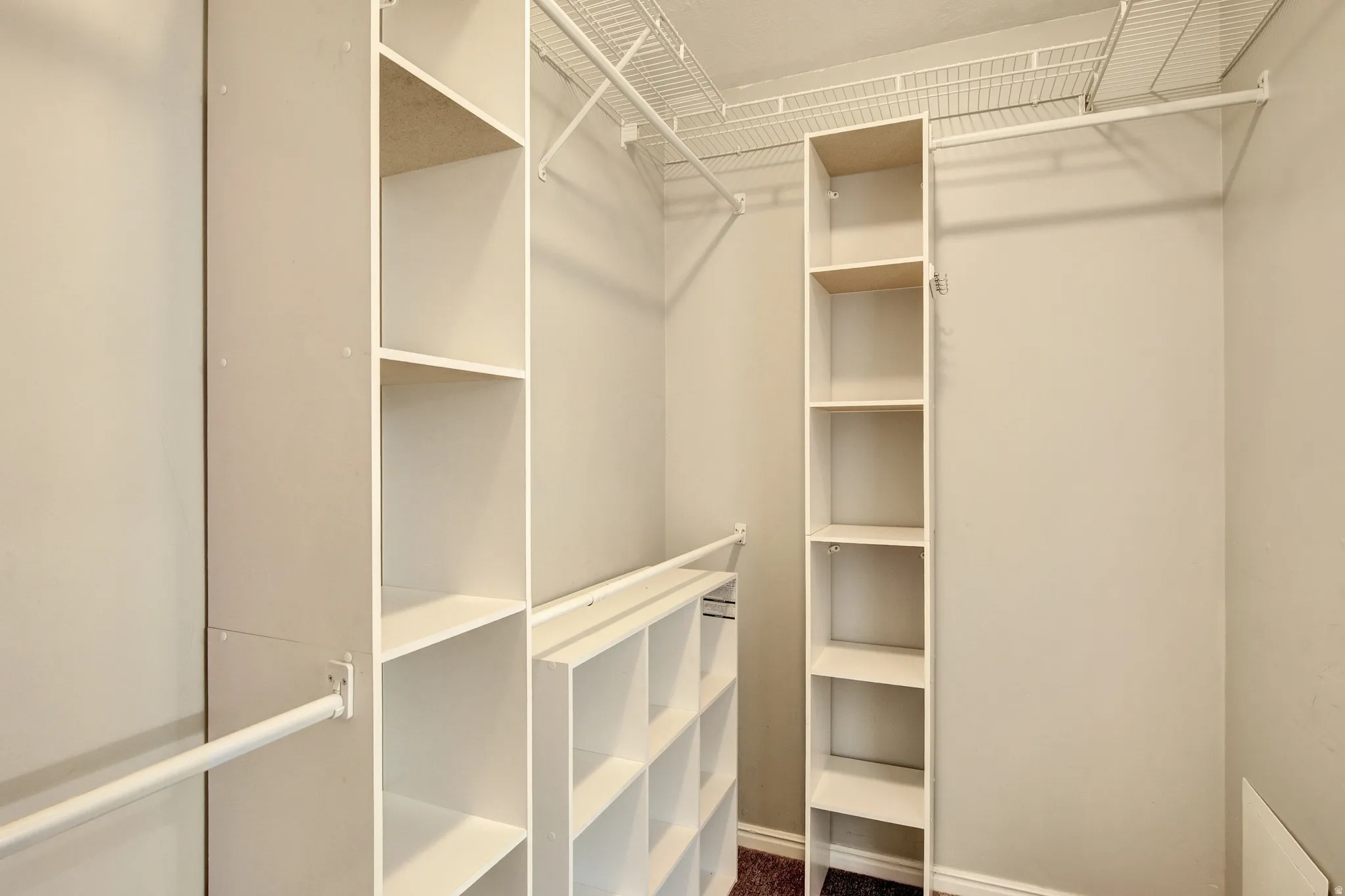 Built-in closet organization system featuring shelving units and hanging rods