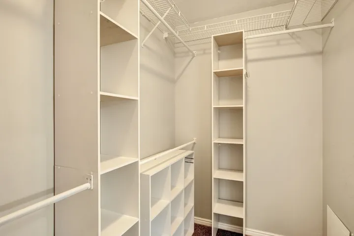 Built-in closet organization system featuring shelving units and hanging rods