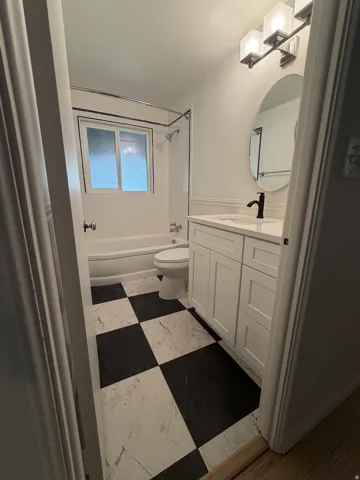 Updated Bathroom with new flooring, new vantiy and sink and new toilet