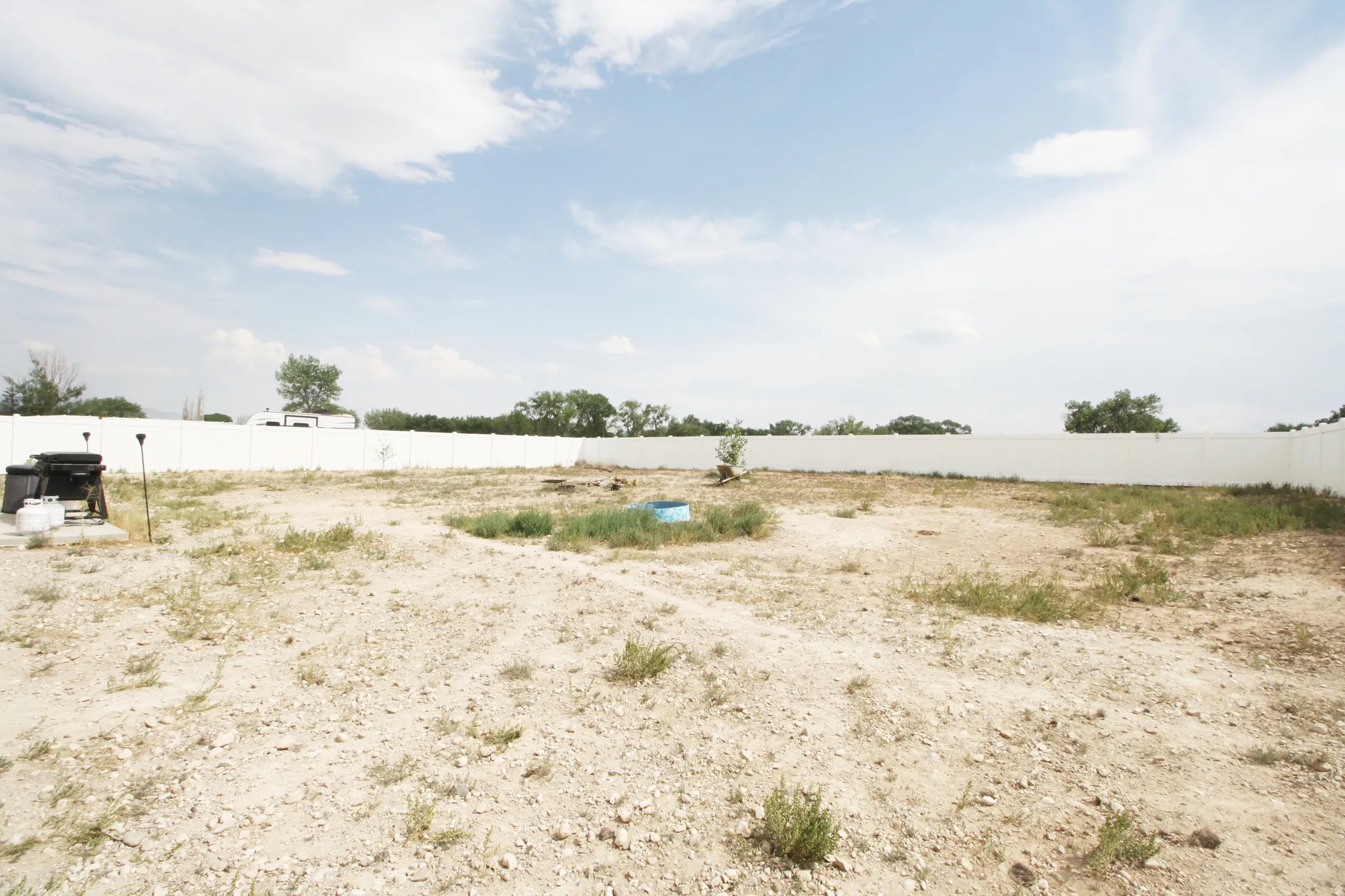 Expansive backyard space featuring a perimeter fence