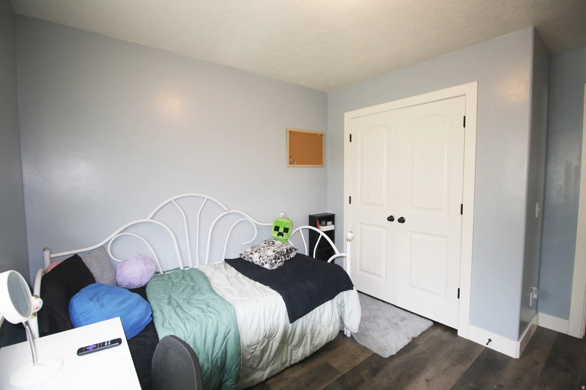 Wood-finish flooring, light blue wall paint, and white trim