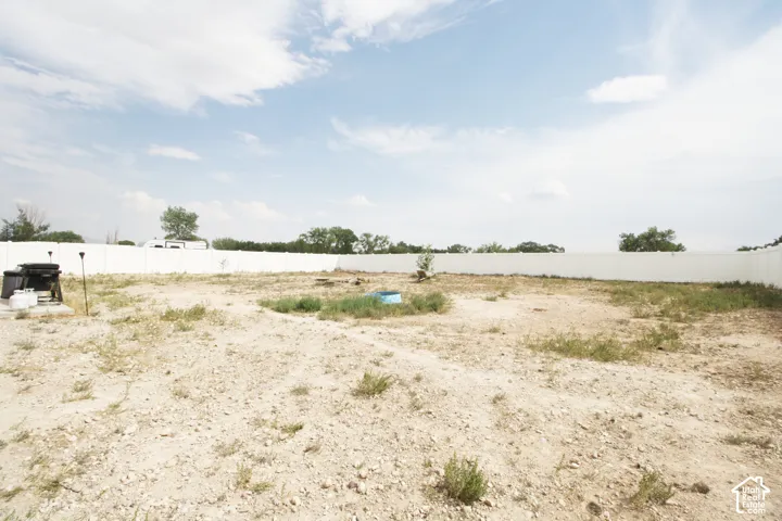 Expansive backyard space featuring a perimeter fence