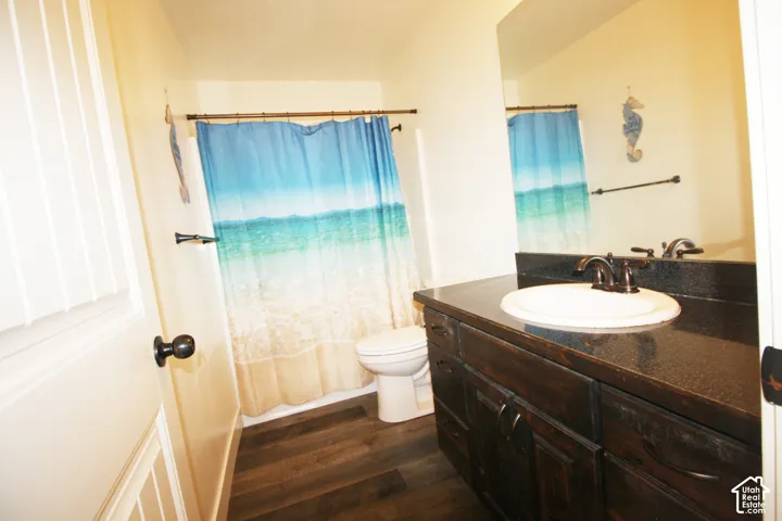 Dark wood-finish vanity with an integrated sink and dark countertop