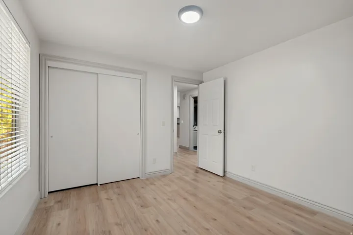 Wood-finish flooring with white baseboards