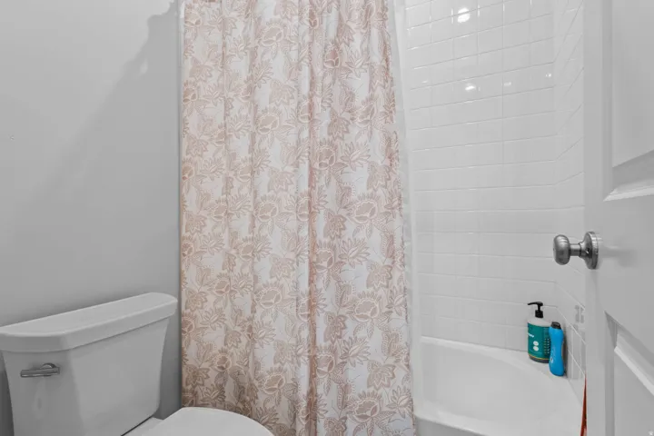 White tile shower surround with a built-in tub
