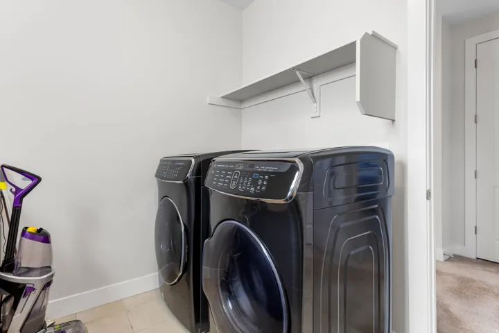 Dedicated laundry area featuring a wall-mounted shelf and hard-surface flooring