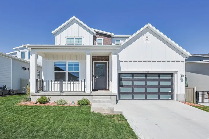 Contemporary exterior with white vertical siding and brick accents