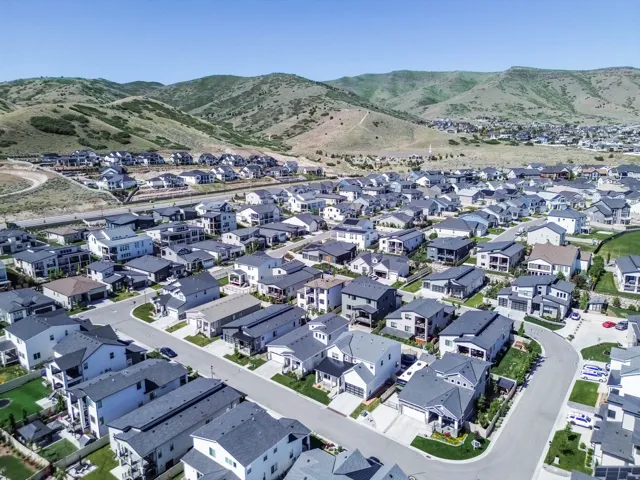 Contemporary residential development featuring a planned community layout with paved streets and uniform housing styles