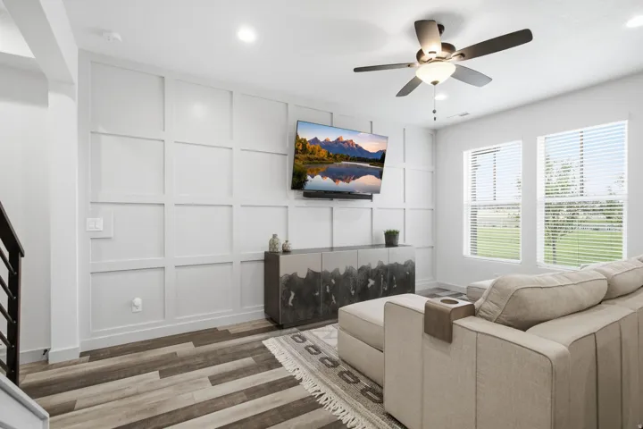 Accent wall with decorative paneling and integrated wall-mounted television