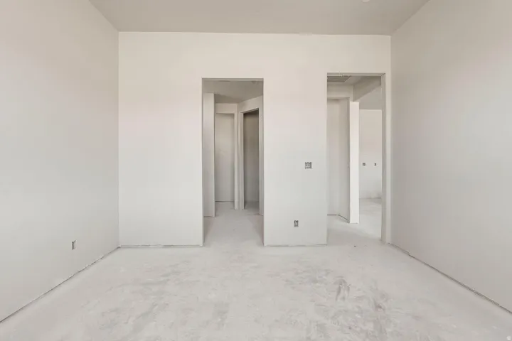 Bright, open interior space with clean drywall finishes and concrete flooring