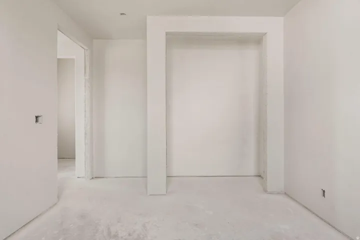 Recessed wall niche, smooth wall finishes, and concrete subflooring