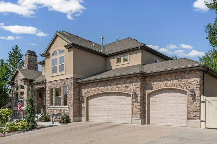 Stucco and stone exterior with architectural shingles