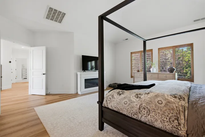 Light wood-finish flooring with a complementary area rug