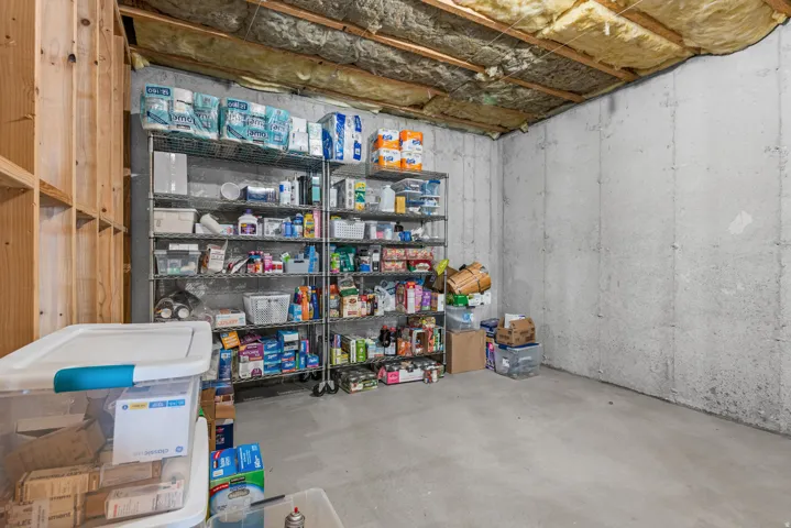 Unfinished basement featuring exposed insulation and concrete walls