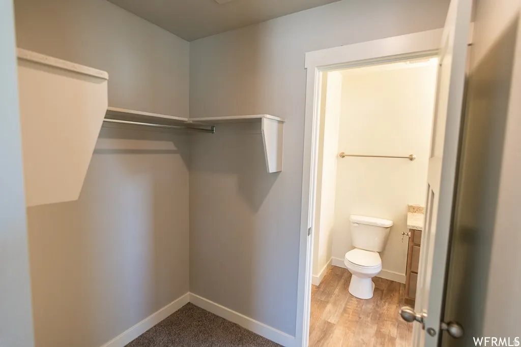 Walk-in closet with built-in shelving and hanging rods