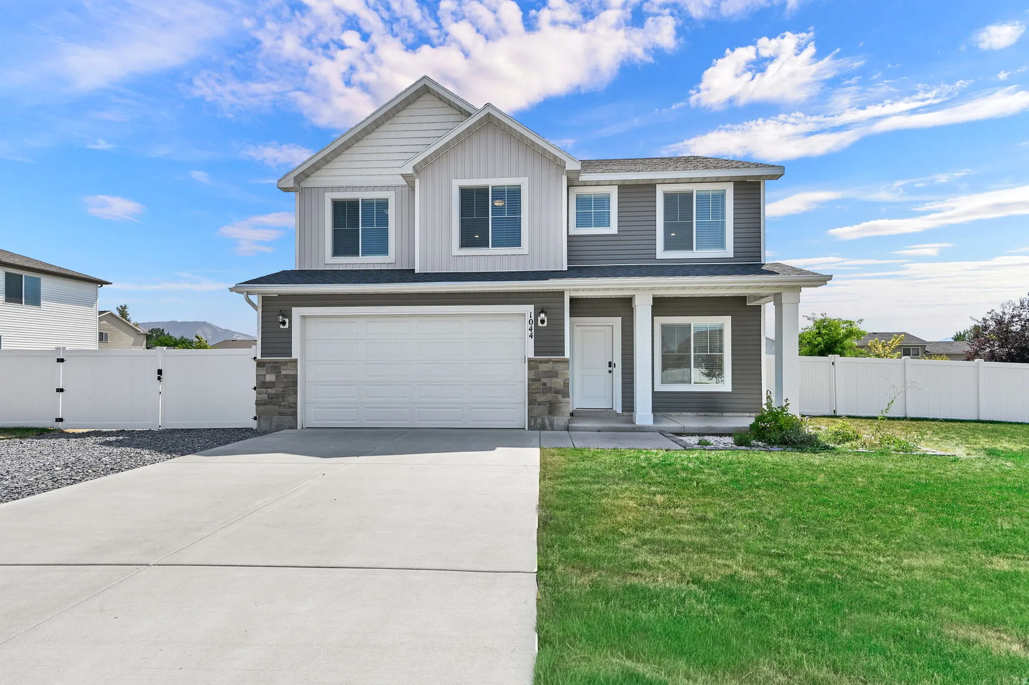 Two-story residence featuring a two-car garage and a concrete driveway