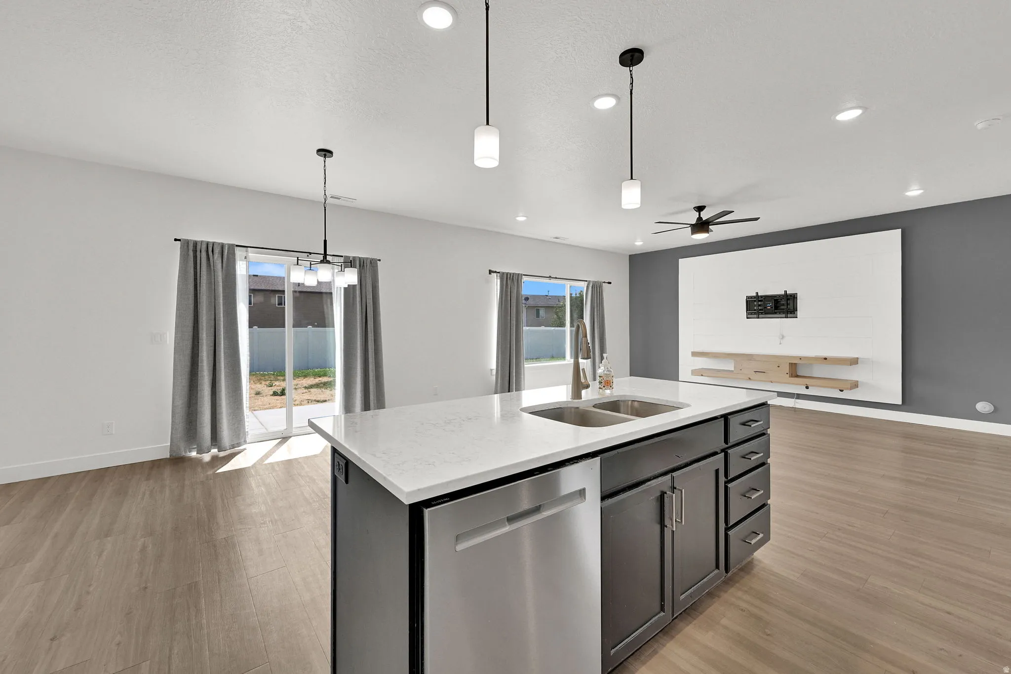 Open-concept living space with wood-finish flooring