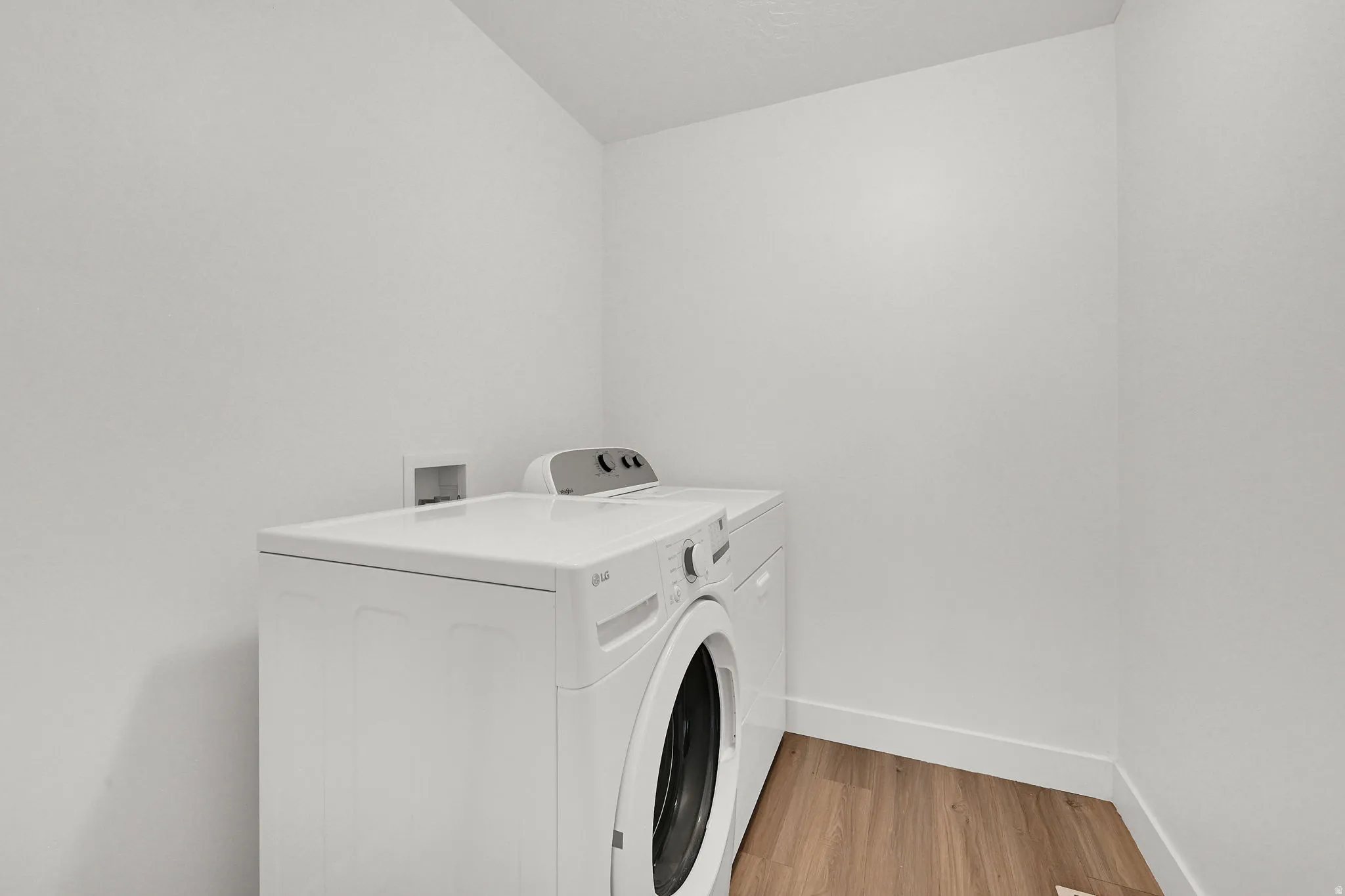 Wood-finish flooring with white wall trim