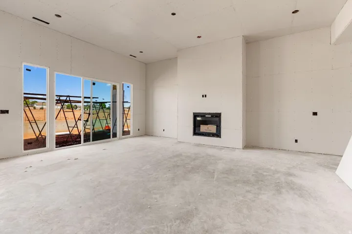 Recessed fireplace, multiple large windows, and an open layout