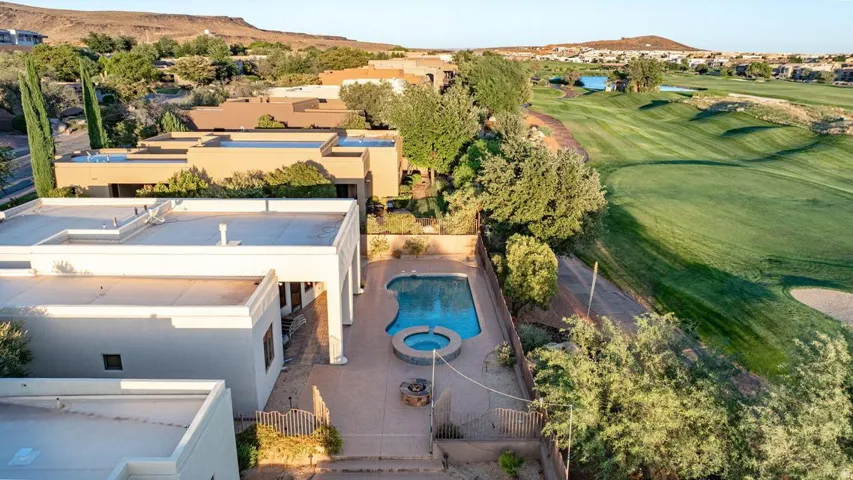 Resort-style property featuring a swimming pool, a hot tub, and a patio area