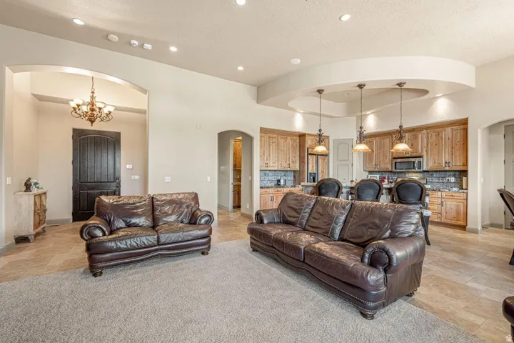 Tray ceiling with recessed lighting and three pendant fixtures