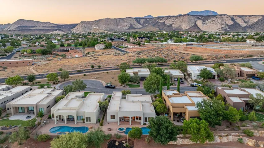 Aerial perspective showcasing a residential community with desert landscaping and mountainous terrain