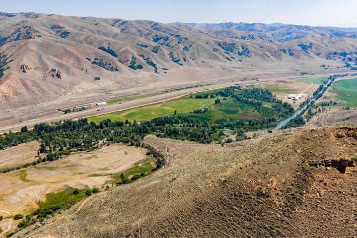 Expansive mountainous terrain with a river cutting through a green valley