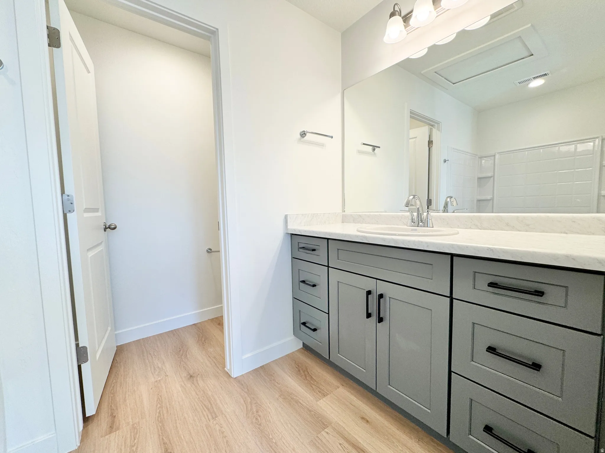 Floating single vanity with a white countertop and undermount sink