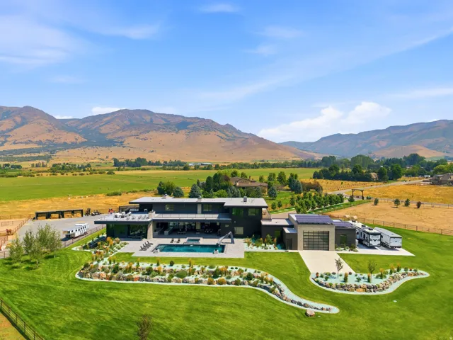 Modern architectural exterior with an expansive lawn, a swimming pool, and a structured landscaping design