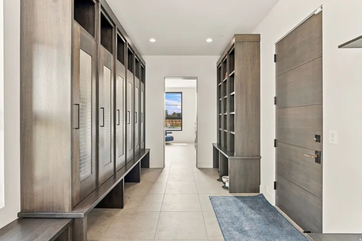 Built-in wood-finish cabinetry, integrated shelving, and ceramic tile flooring