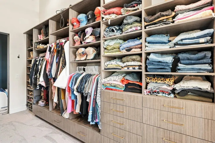 Built-in closet system with varied shelving, hanging rods, and integrated drawers