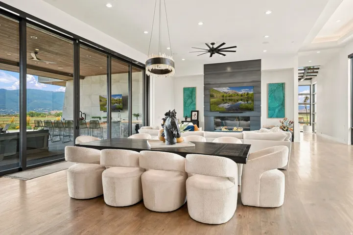 Spacious interior featuring wood-finish flooring, a contemporary fireplace, and recessed lighting