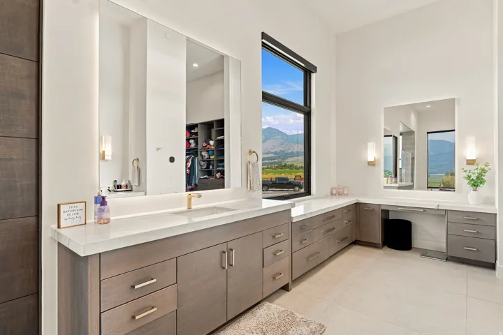 Extended vanity with dual sinks, built-in storage, and integrated lighting