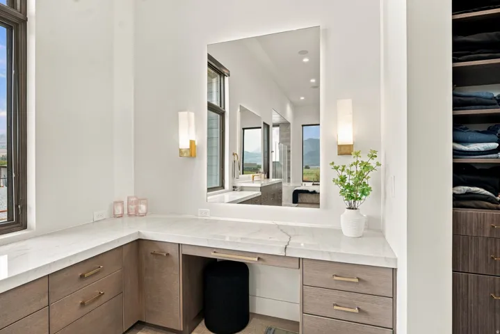 Corner vanity with a light-colored countertop and integrated seating area