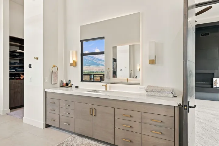 Dual vanity with a stone countertop and integrated sinks