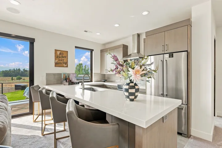 Kitchen featuring a large center island with a light-toned countertop, stainless steel appliances, a tile backsplash, and recessed lighting