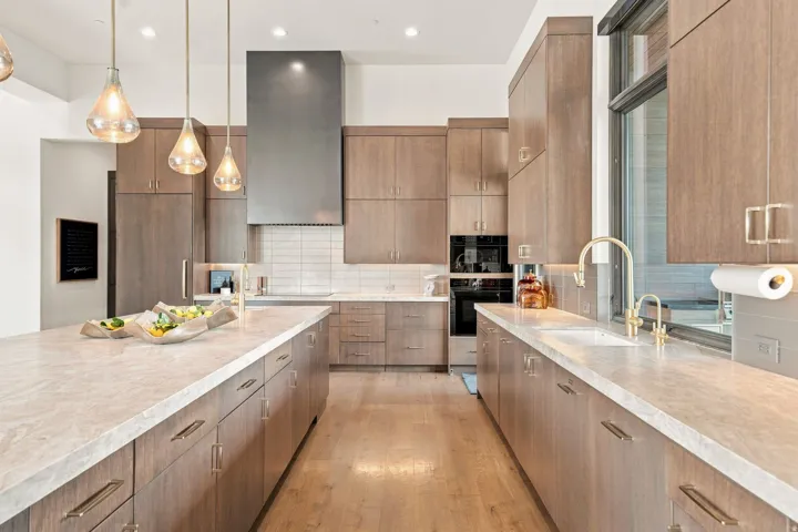 Kitchen featuring light wood-finish cabinetry, light-toned countertops, and light wood-finish flooring